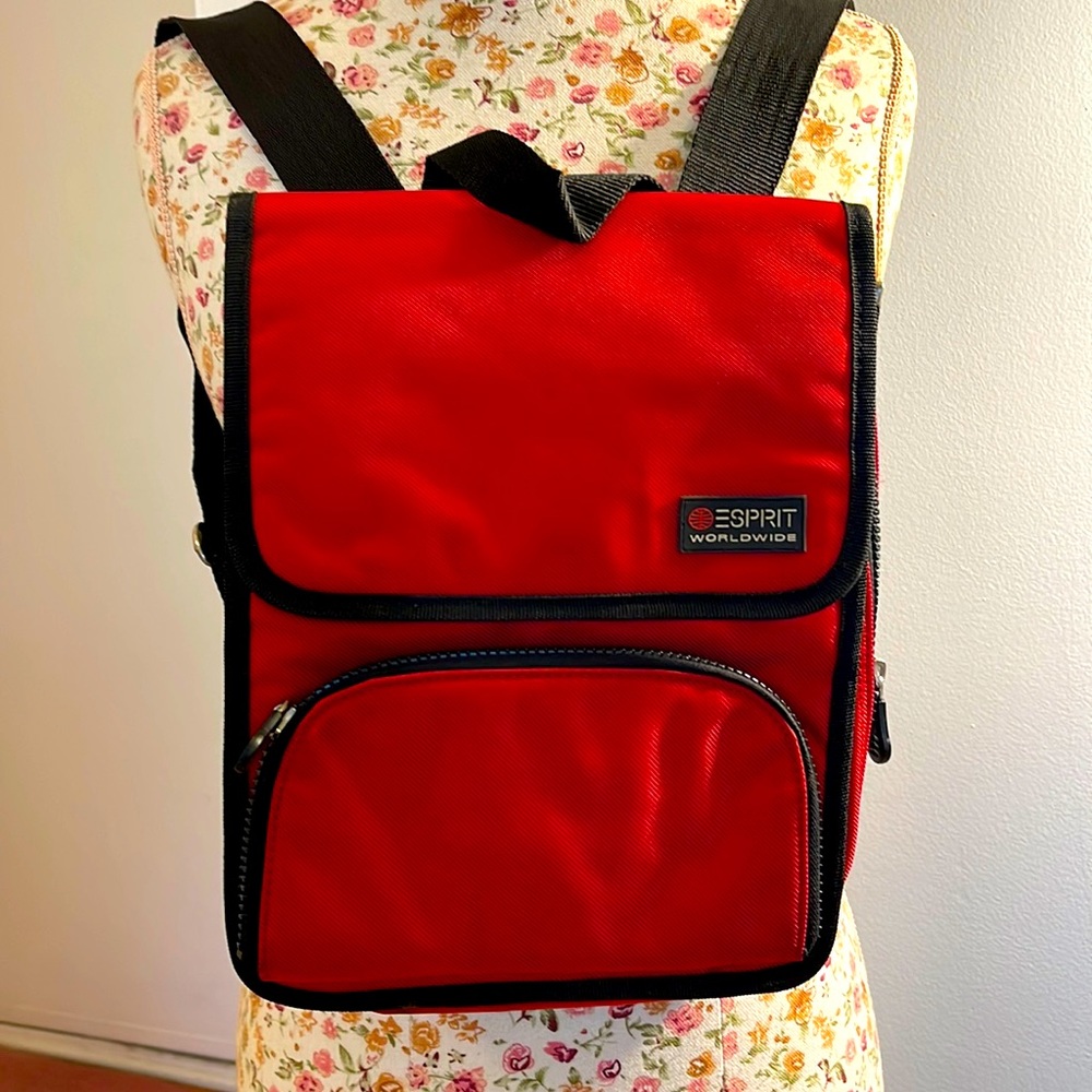 Esprit back pack with front snap closure. Zippered pocket in the front.